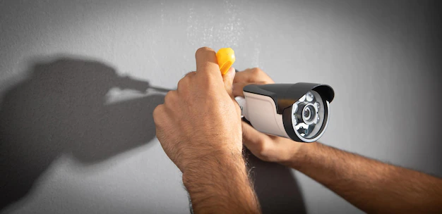 technician-installing-cctv-camera-system-home_220873-12845